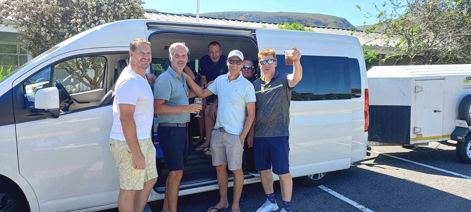 Guests arriving beside a Stellenbosch Shuttles minibus with luggage trailer after an airport transfer